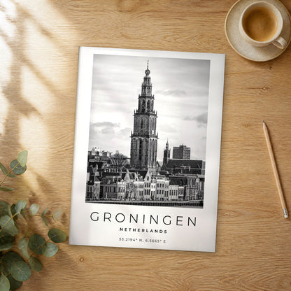 Unframed Groningen black and white travel poster on a wooden table