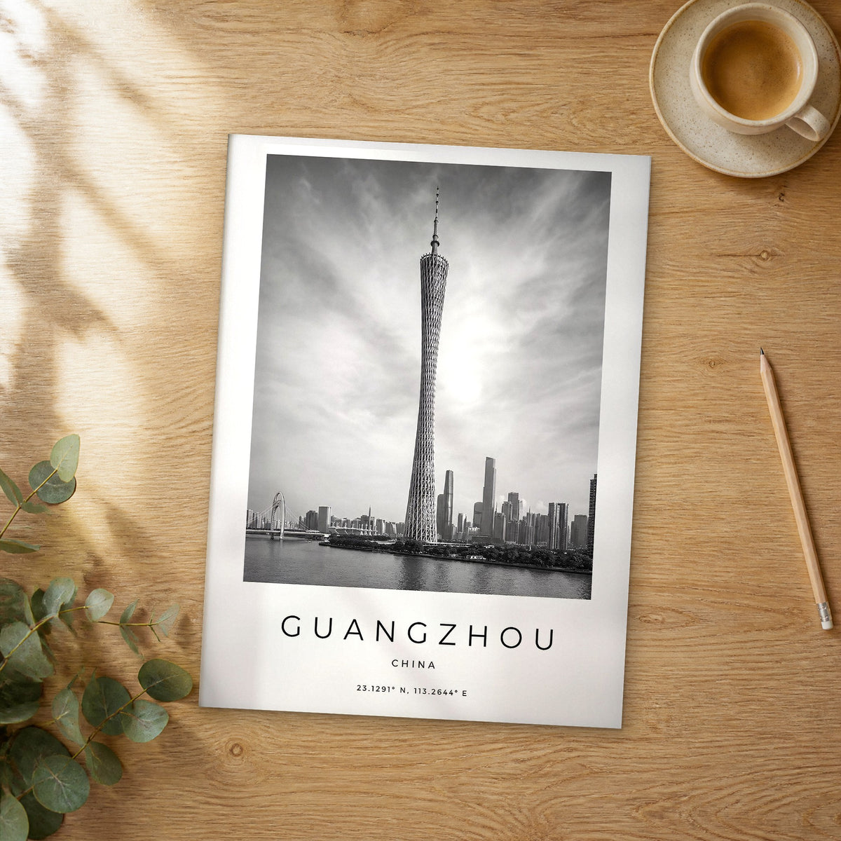 Unframed Guangzhou black and white travel poster on a wooden table