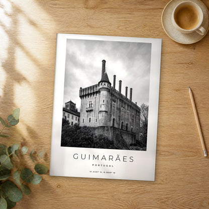 Unframed Guimarães black and white travel poster on a wooden table