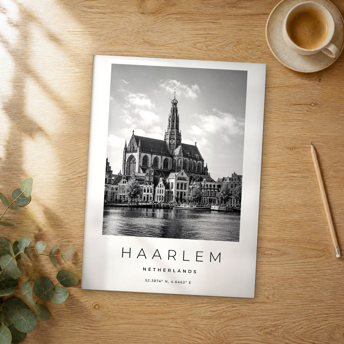 Unframed Haarlem black and white travel poster on a wooden table