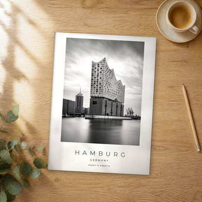 Unframed Hamburg black and white travel poster on a wooden table