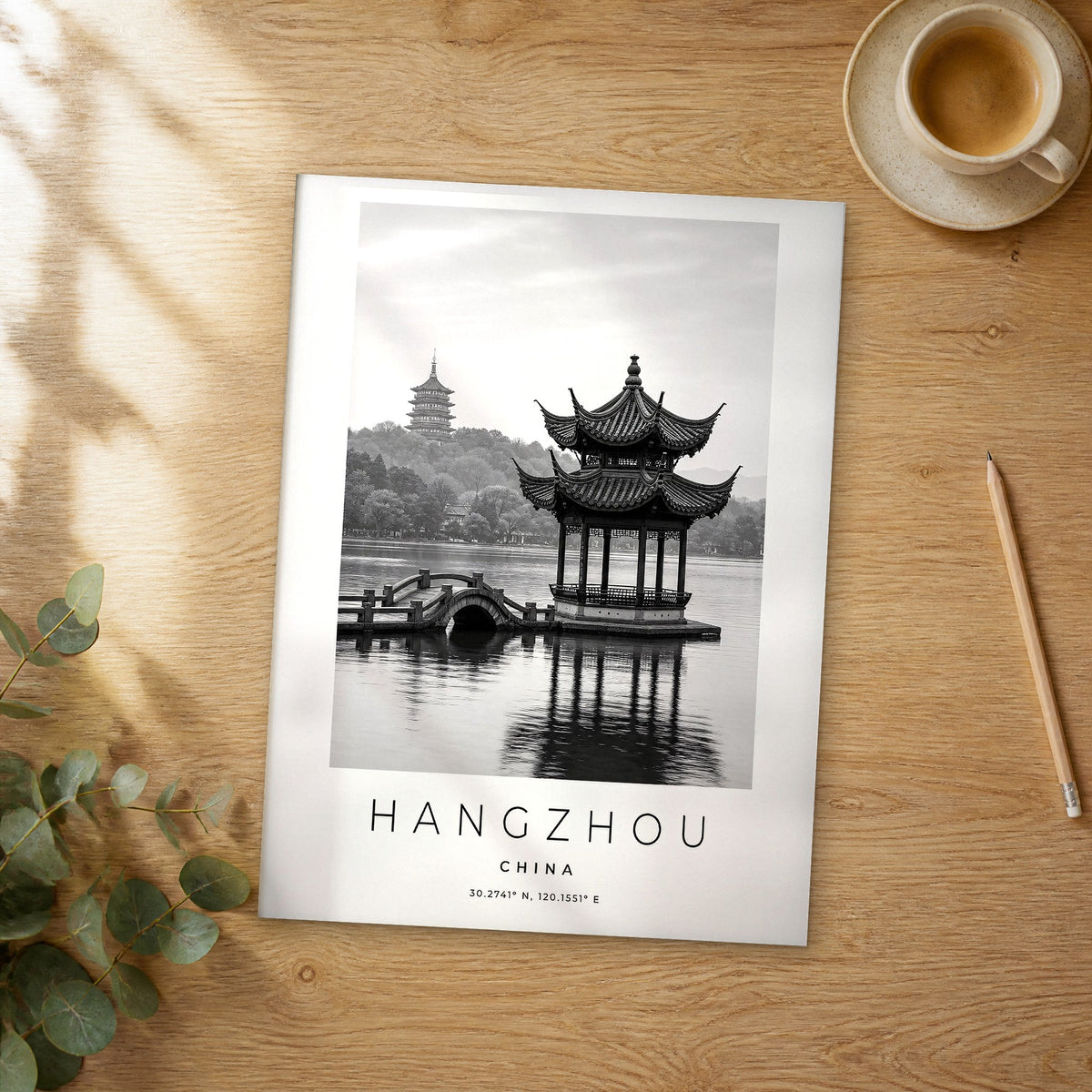 Unframed Hangzhou black and white travel poster on a wooden table