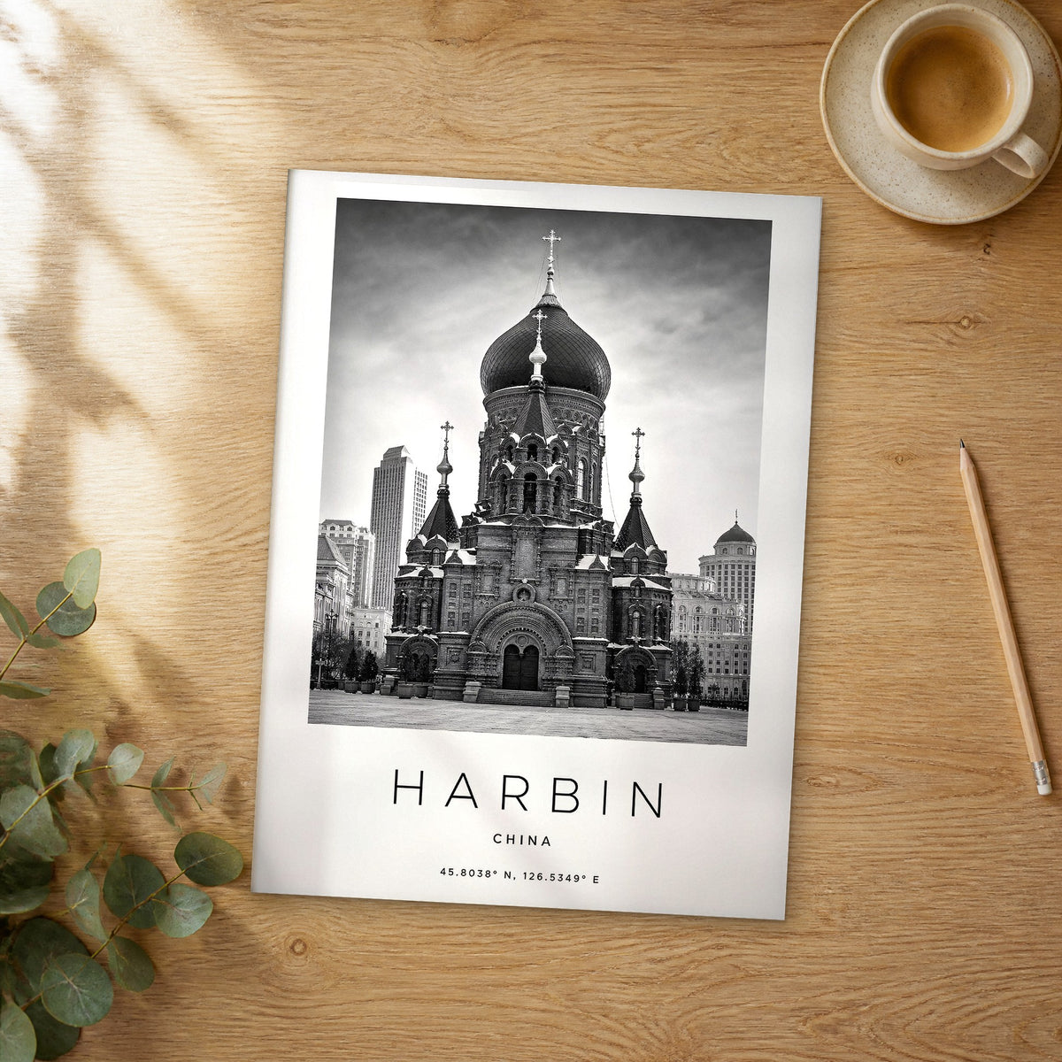 Unframed Harbin black and white travel poster on a wooden table