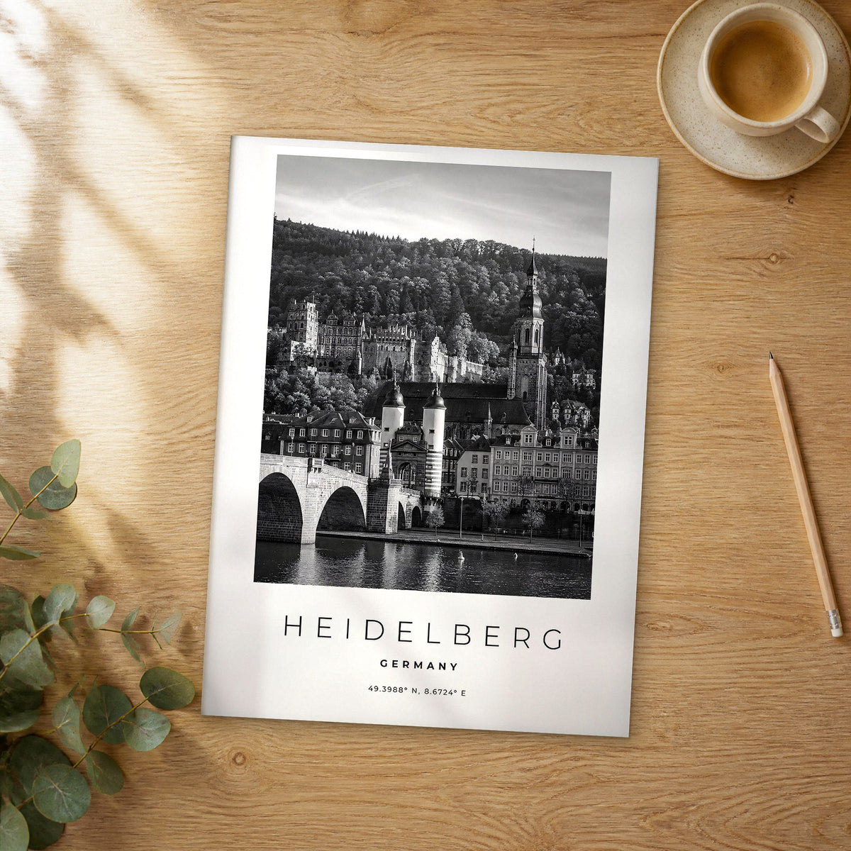 Unframed Heidelberg black and white travel poster on a wooden table