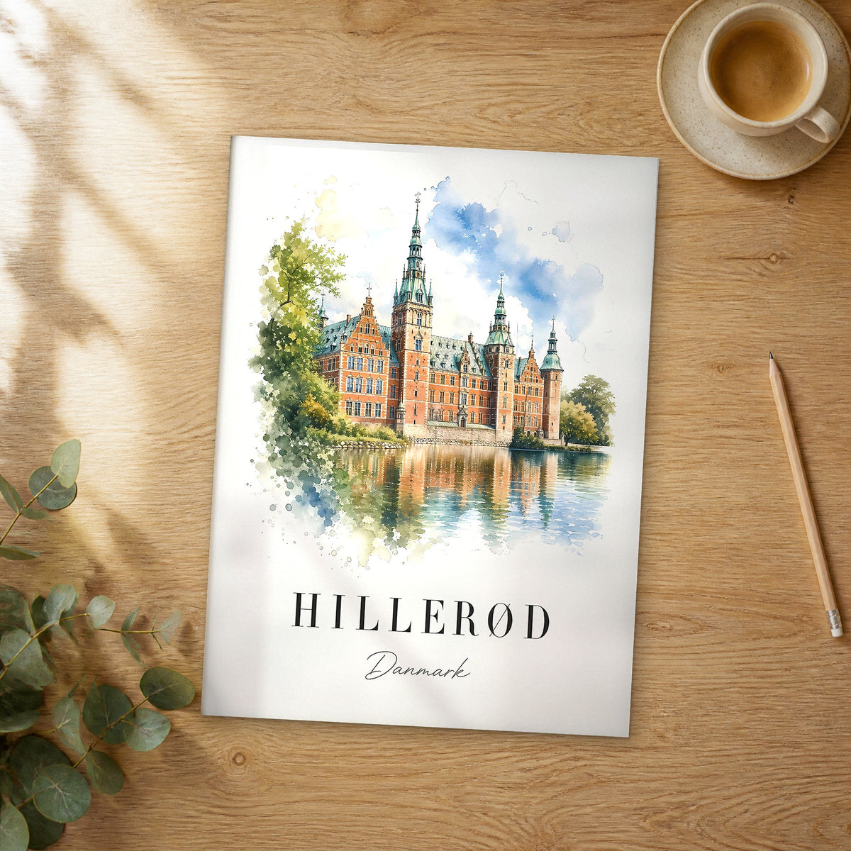 Unframed Hillerød watercolor travel poster on a wooden table