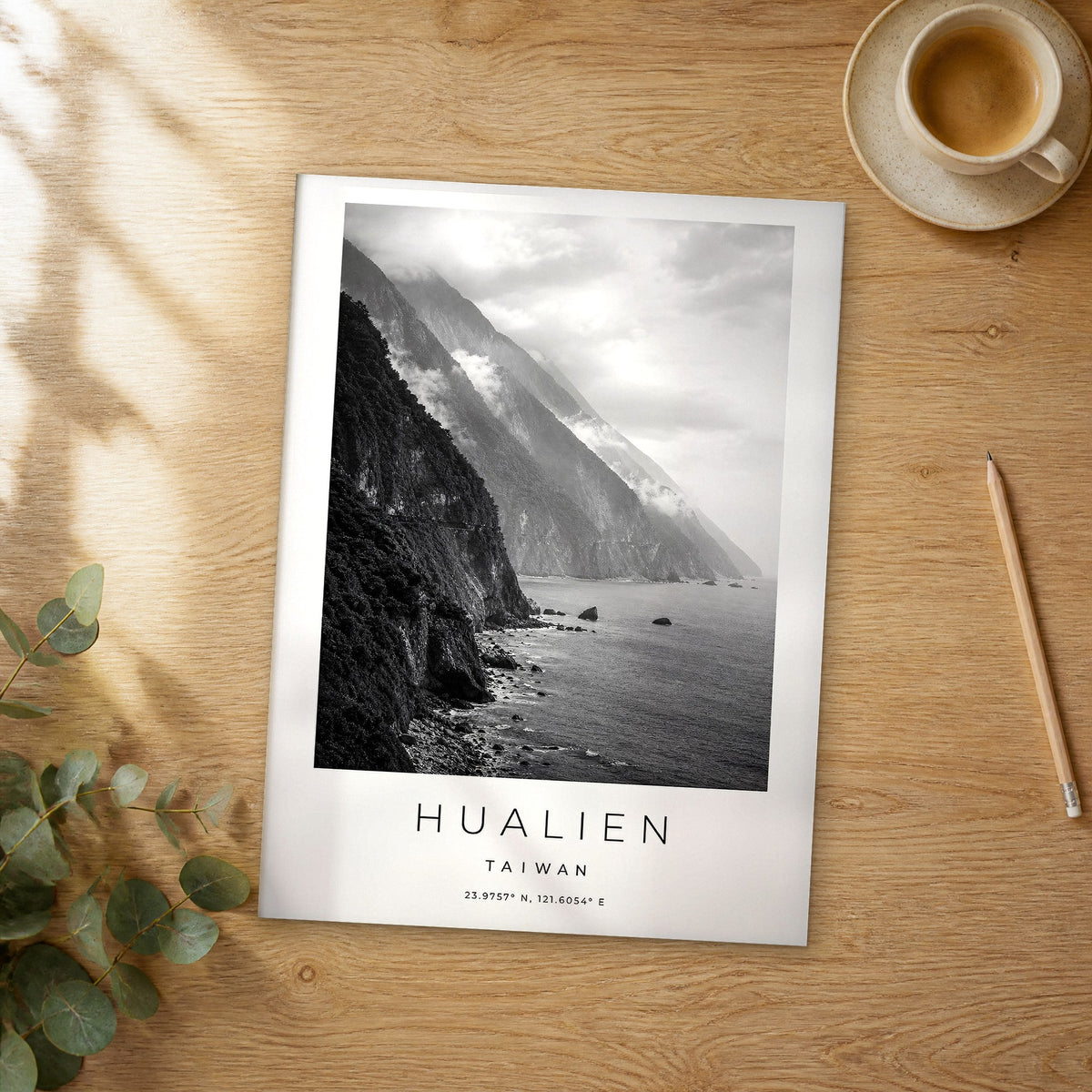 Unframed Hualien black and white travel poster on a wooden table