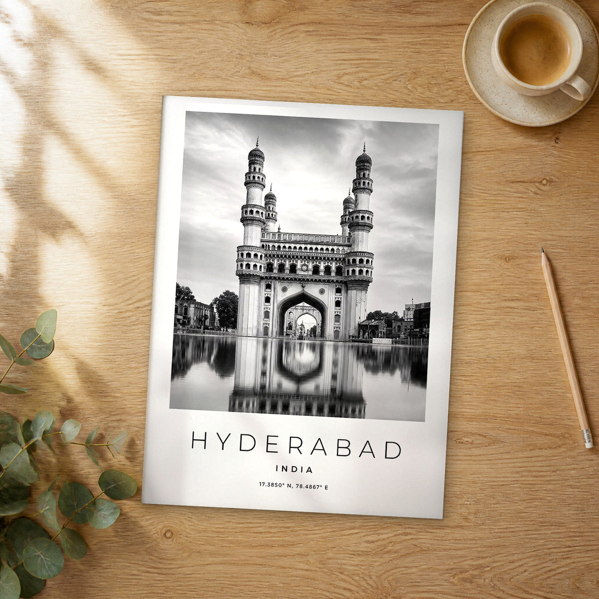 Unframed Hyderabad black and white travel poster on a wooden table