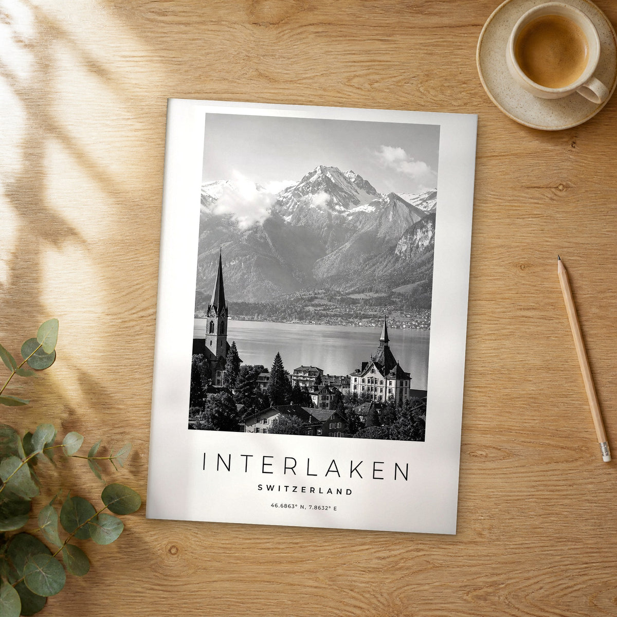 Unframed Interlaken black and white travel poster on a wooden table