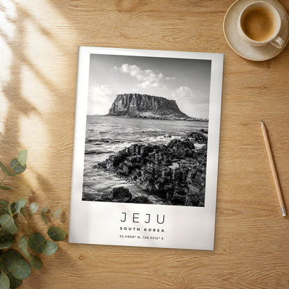 Unframed Jeju black and white travel poster on a wooden table