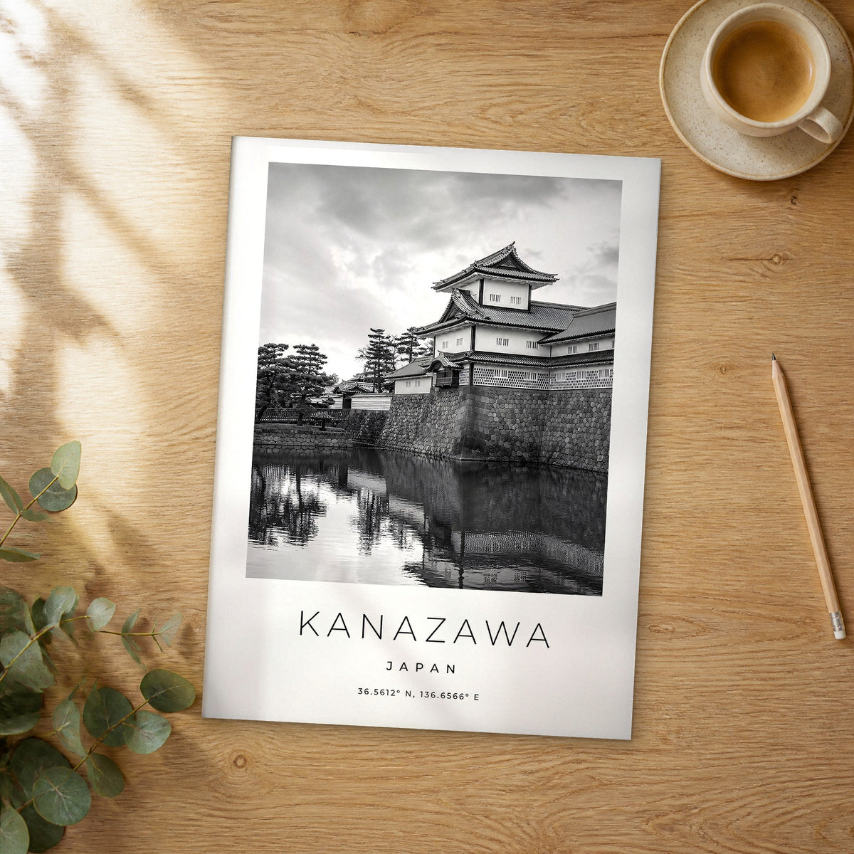 Unframed Kanazawa black and white travel poster on a wooden table