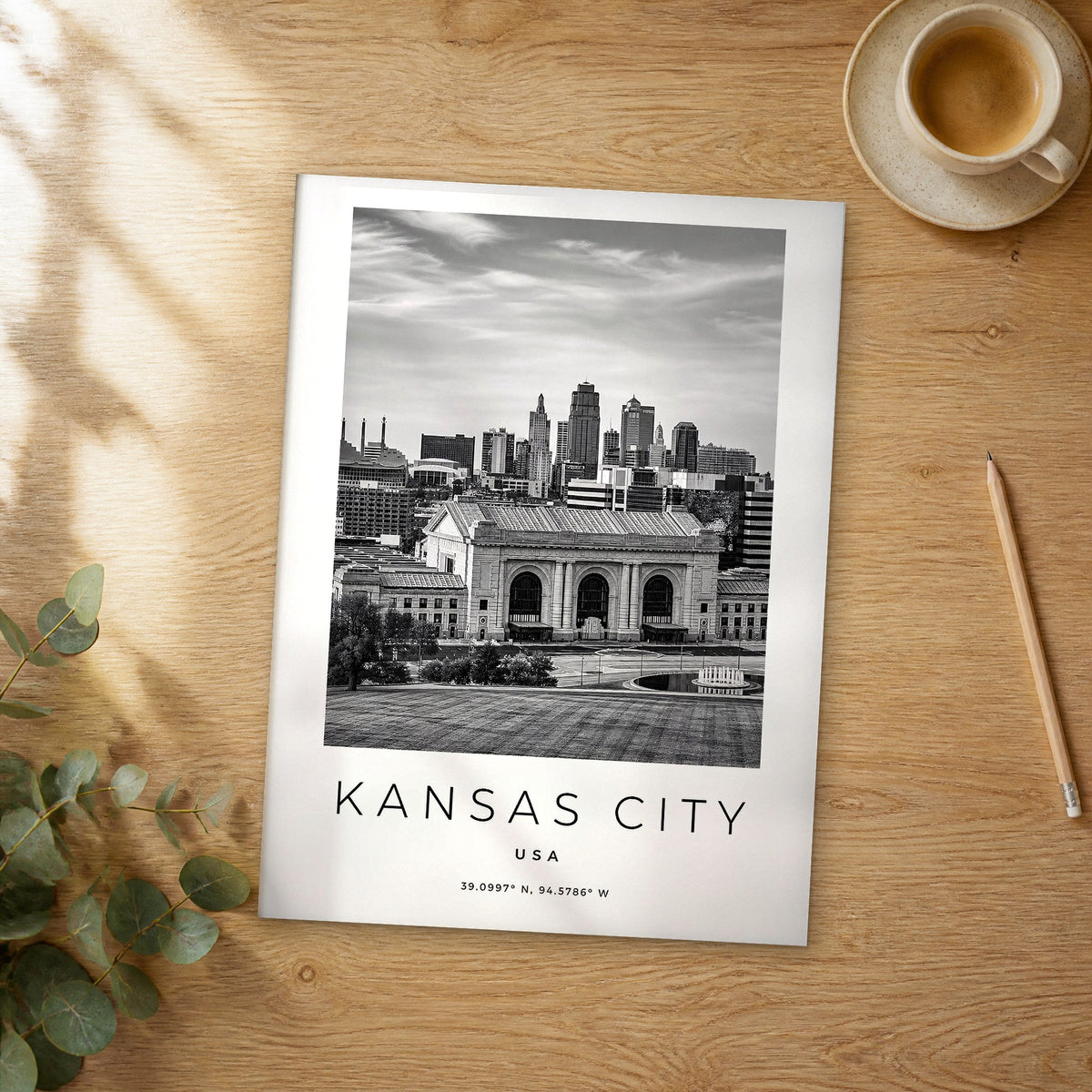 Unframed Kansas City black and white travel poster on a wooden table
