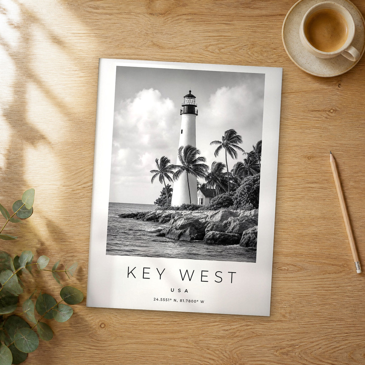Unframed Key West black and white travel poster on a wooden table