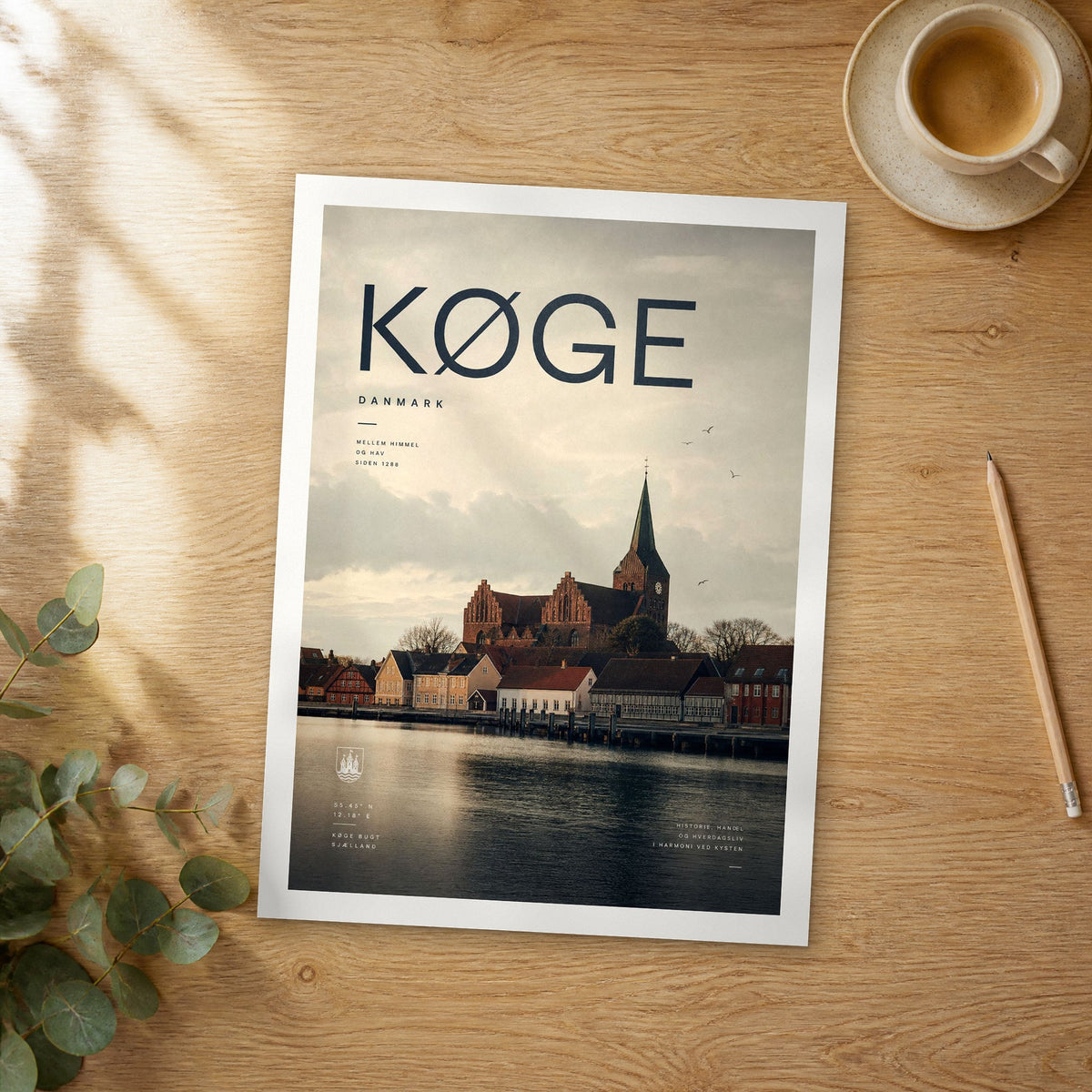 Unframed Køge bold typography travel poster on a wooden table