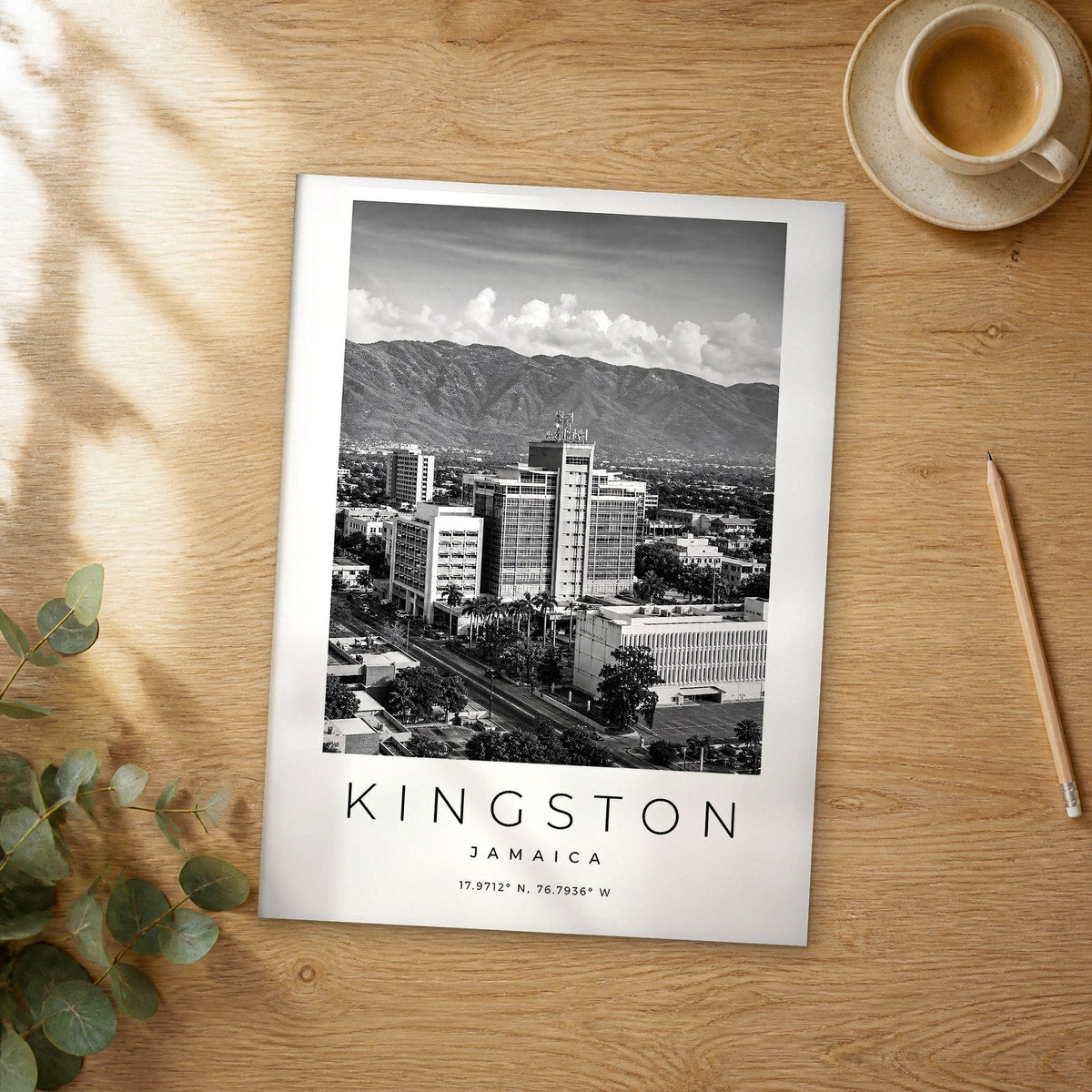 Unframed Kingston black and white travel poster on a wooden table