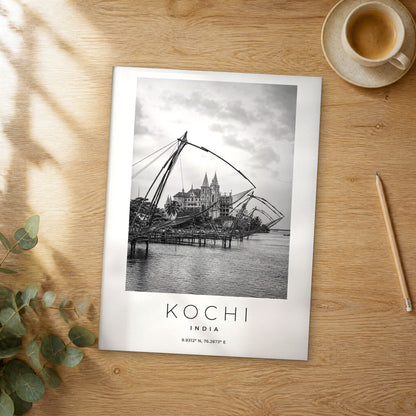 Unframed Kochi black and white travel poster on a wooden table