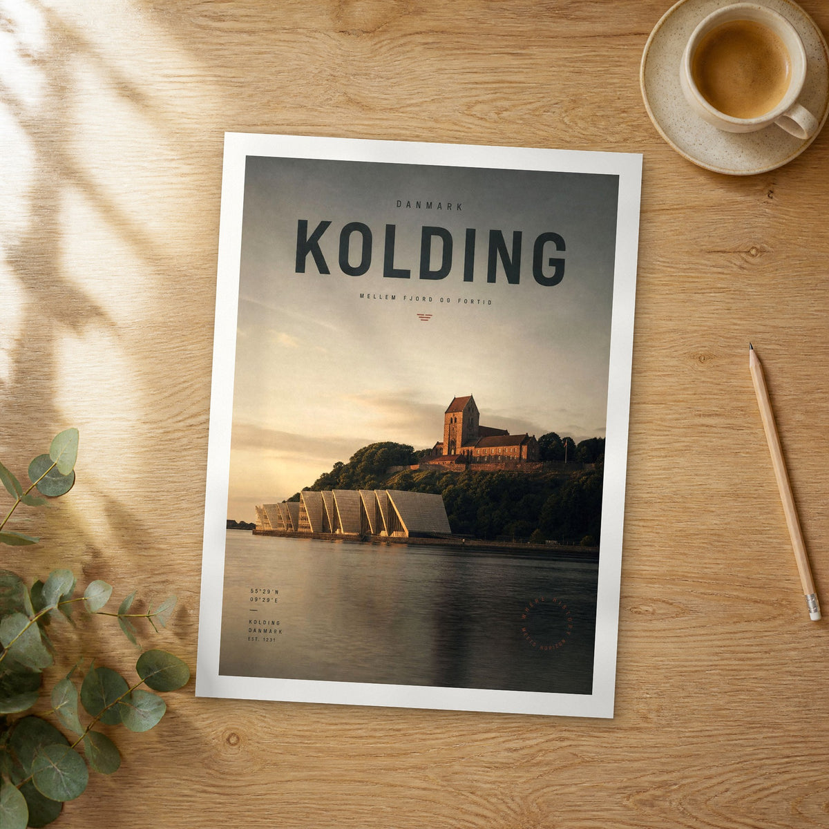 Unframed Kolding bold typography travel poster on a wooden table