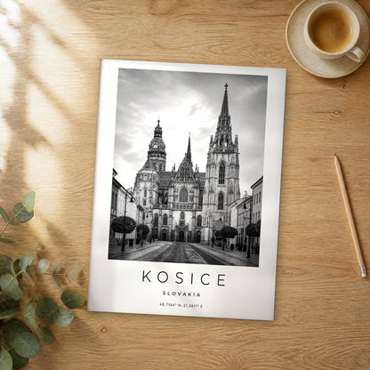 Unframed Kosice black and white travel poster on a wooden table