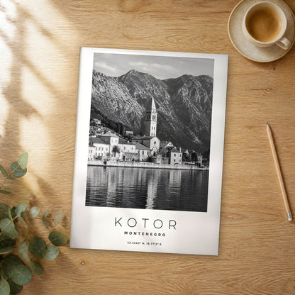 Unframed Kotor black and white travel poster on a wooden table