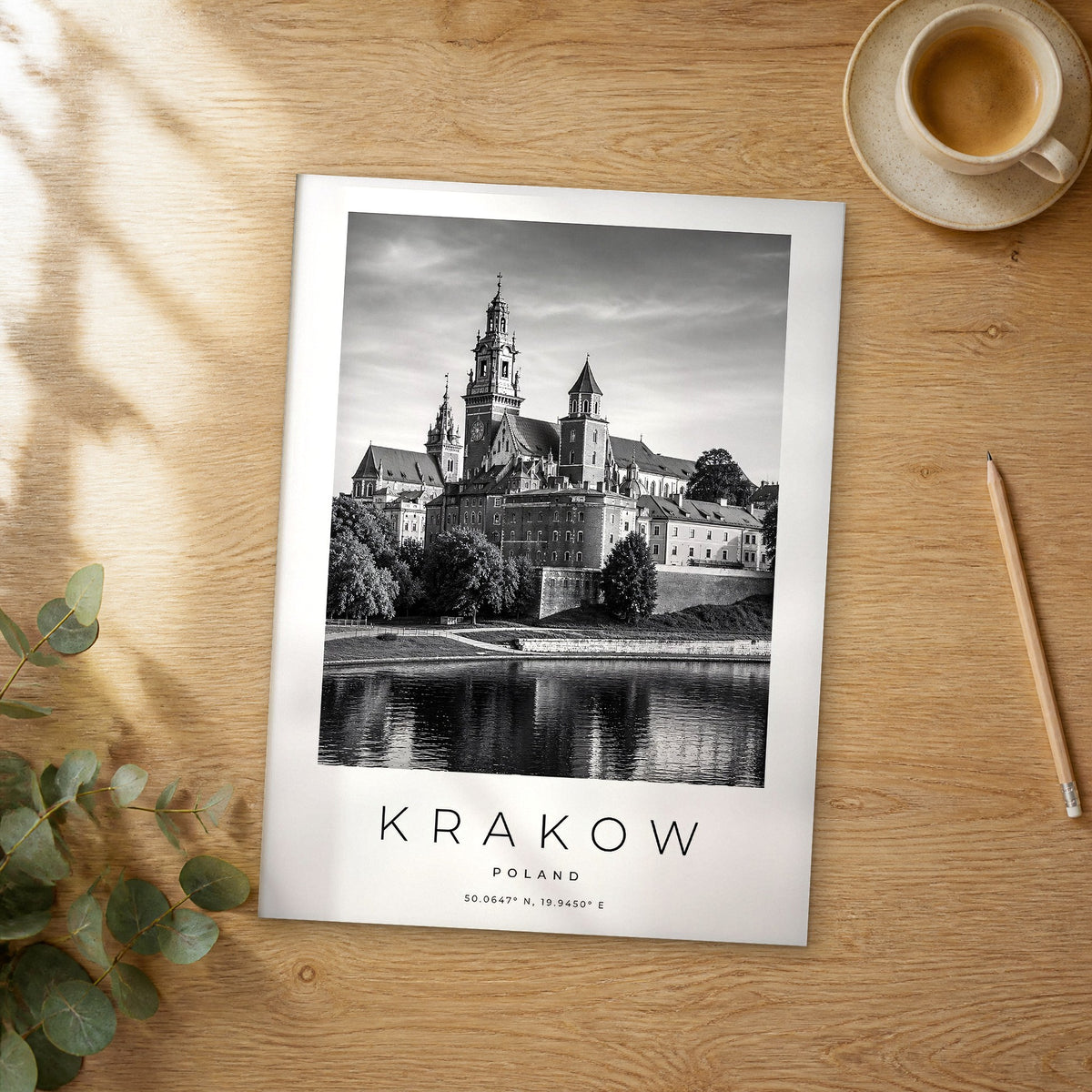 Unframed Krakow black and white travel poster on a wooden table