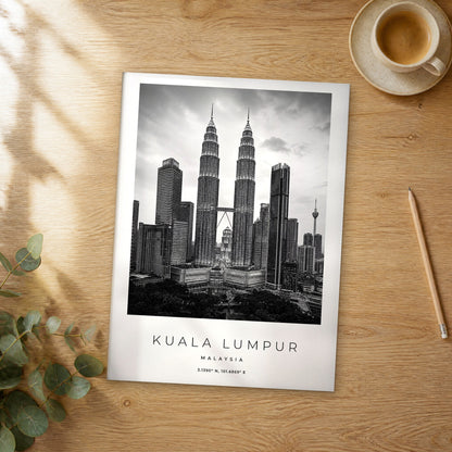 Unframed Kuala Lumpur black and white travel poster on a wooden table