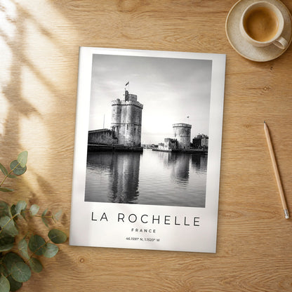 Unframed La Rochelle black and white travel poster on a wooden table