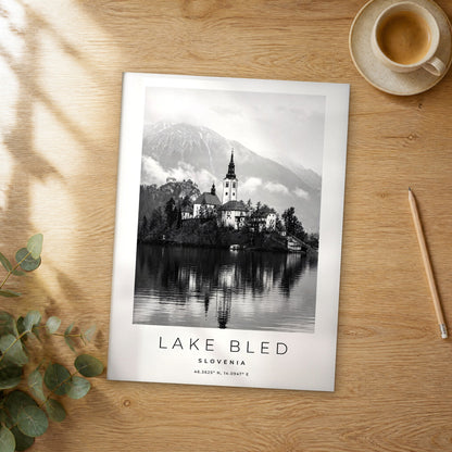 Unframed Lake Bled black and white travel poster on a wooden table