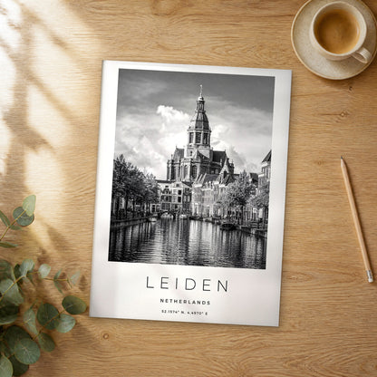 Unframed Leiden black and white travel poster on a wooden table