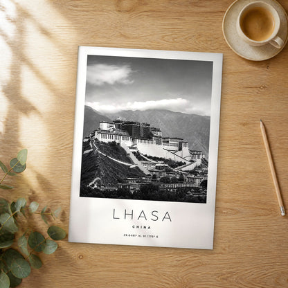 Unframed Lhasa black and white travel poster on a wooden table