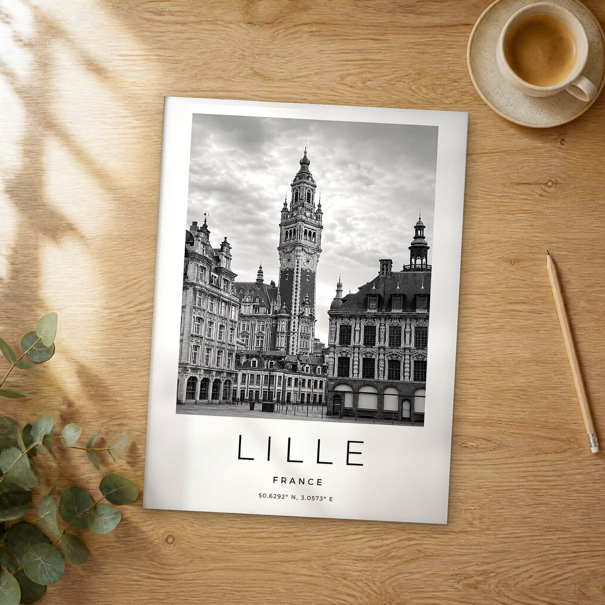Unframed Lille black and white travel poster on a wooden table