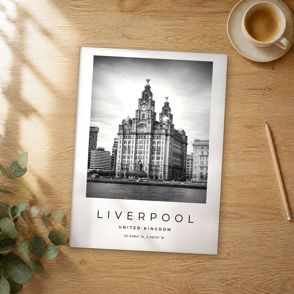 Unframed Liverpool black and white travel poster on a wooden table