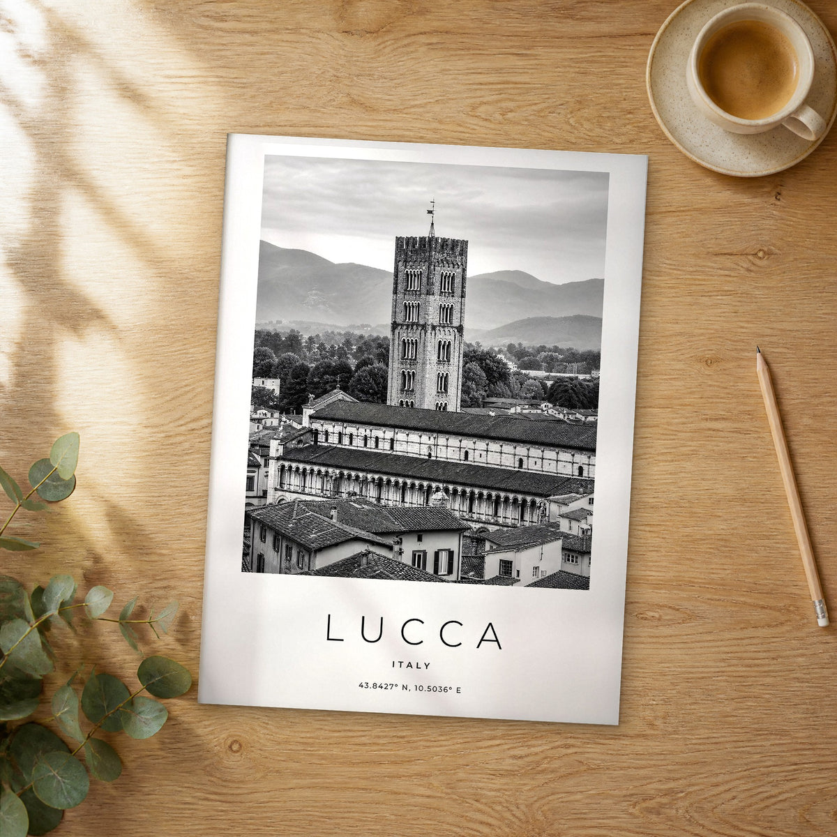 Unframed Lucca black and white travel poster on a wooden table