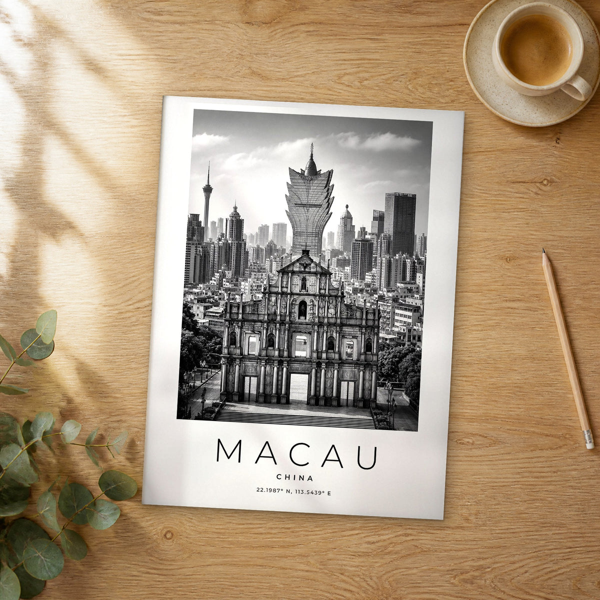 Unframed Macau black and white travel poster on a wooden table