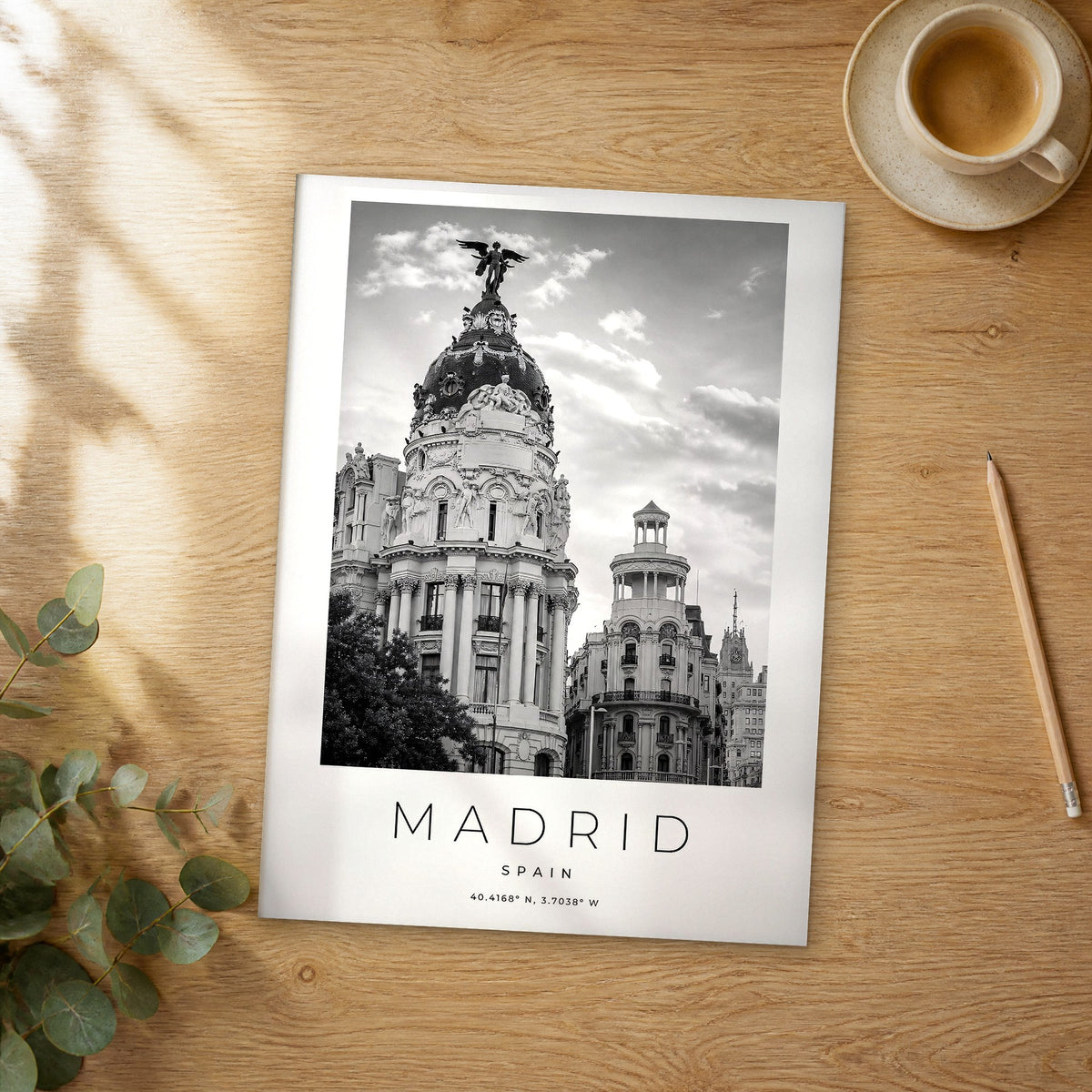 Unframed Madrid black and white travel poster on a wooden table