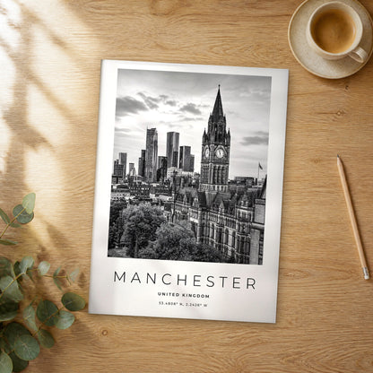 Unframed Manchester black and white travel poster on a wooden table