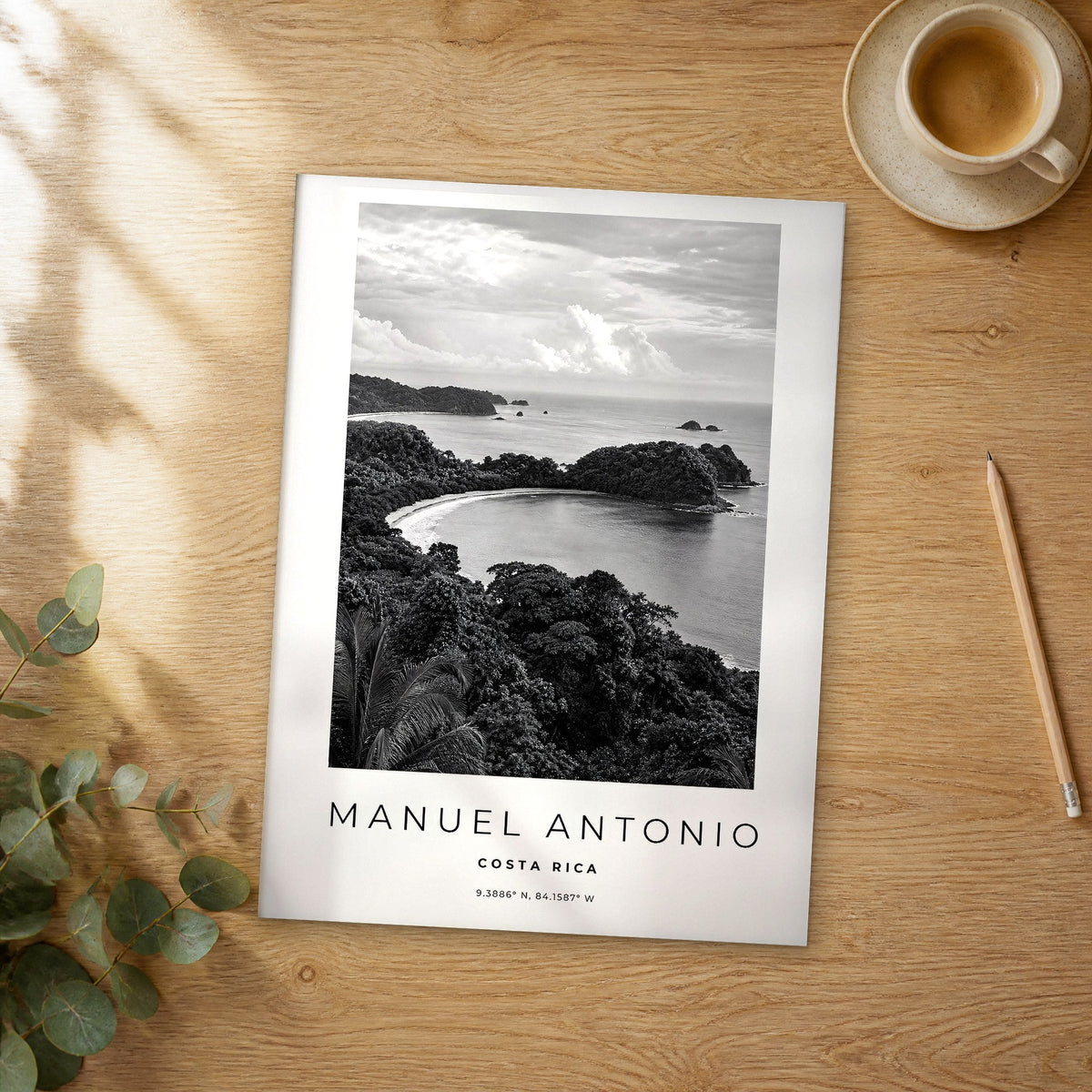 Unframed Manuel Antonio black and white travel poster on a wooden table