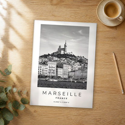 Unframed Marseille black and white travel poster on a wooden table