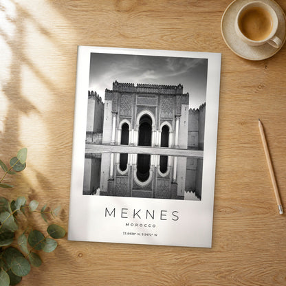 Unframed Meknes black and white travel poster on a wooden table