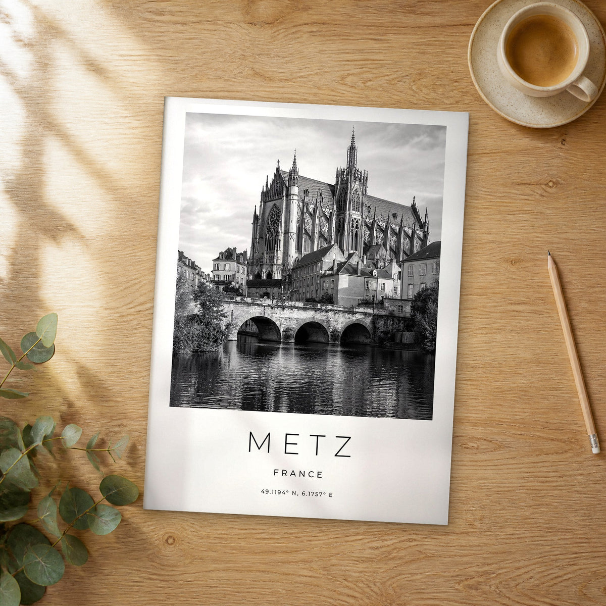 Unframed Metz black and white travel poster on a wooden table