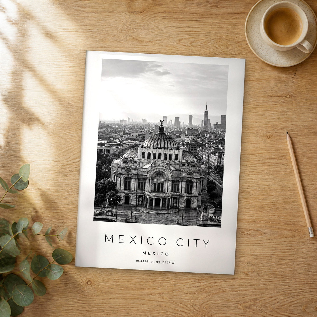Unframed Mexico City black and white travel poster on a wooden table