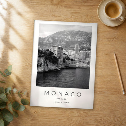 Unframed Monaco black and white travel poster on a wooden table
