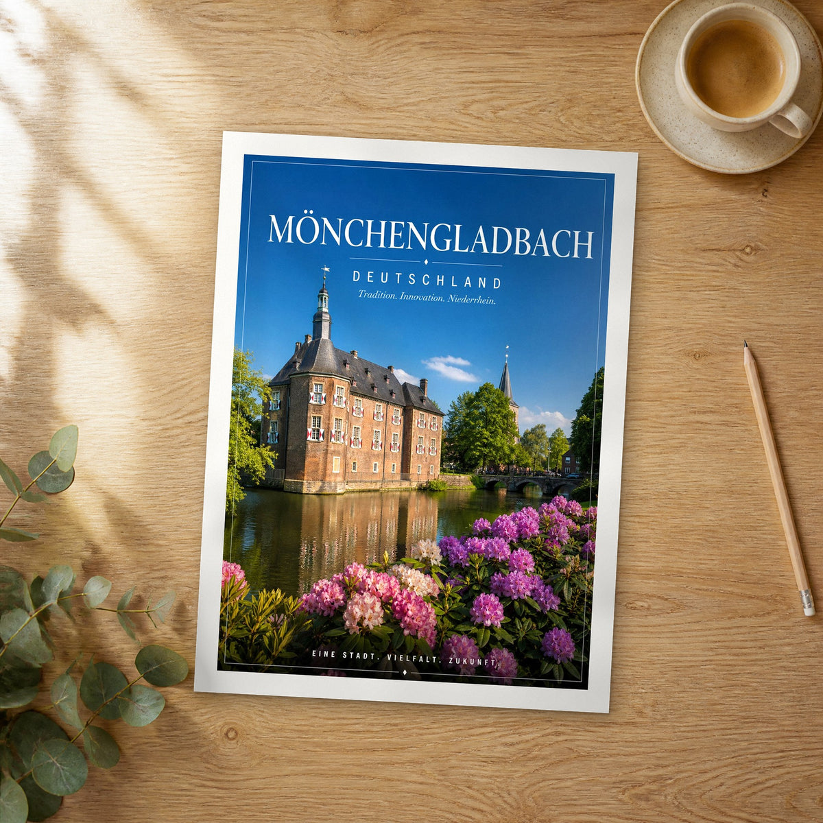 Unframed Mönchengladbach editorial travel poster on a wooden table