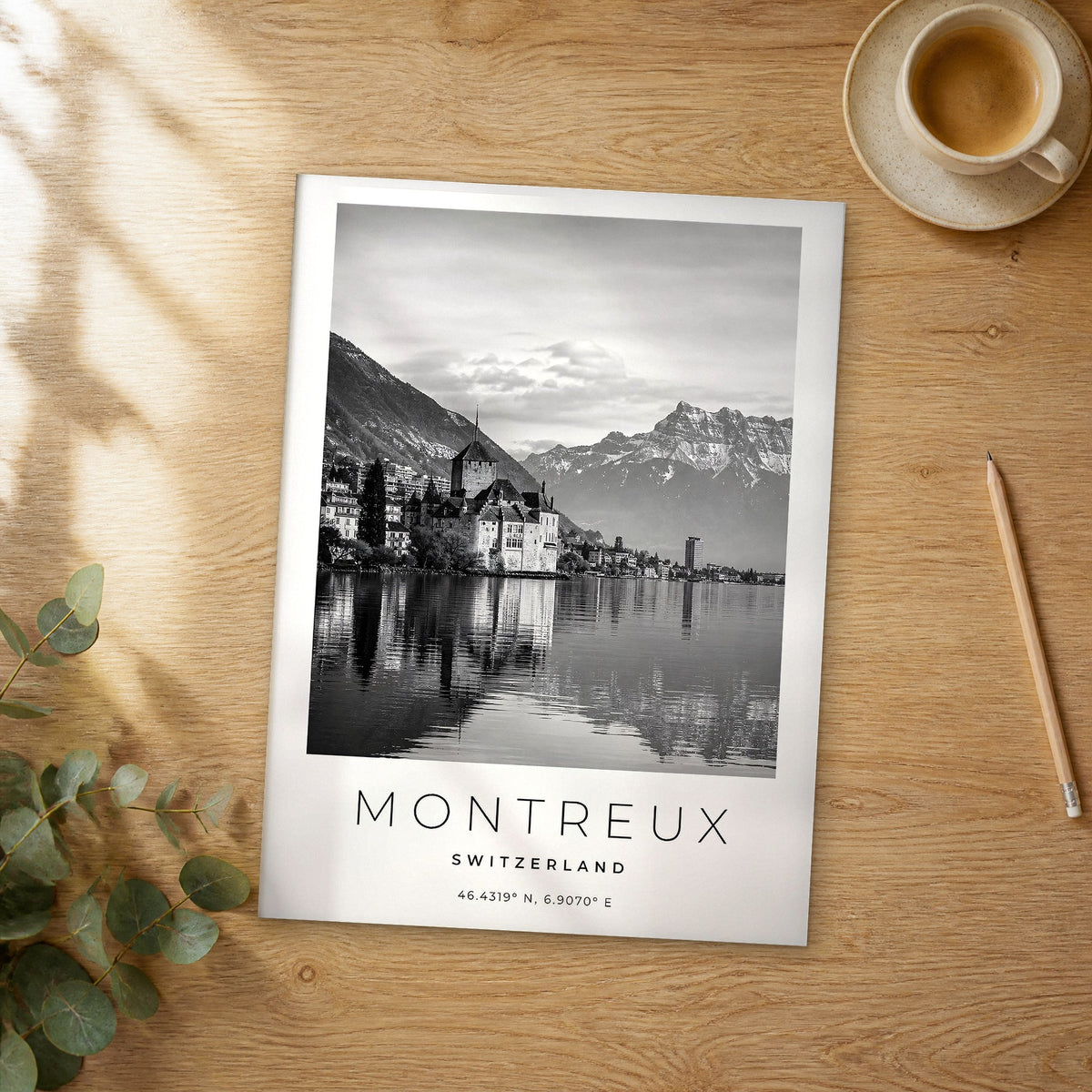 Unframed Montreux black and white travel poster on a wooden table