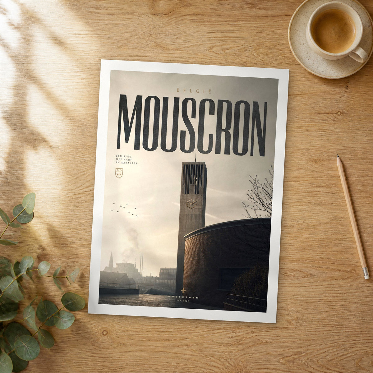 Unframed Mouscron bold typography travel poster on a wooden table