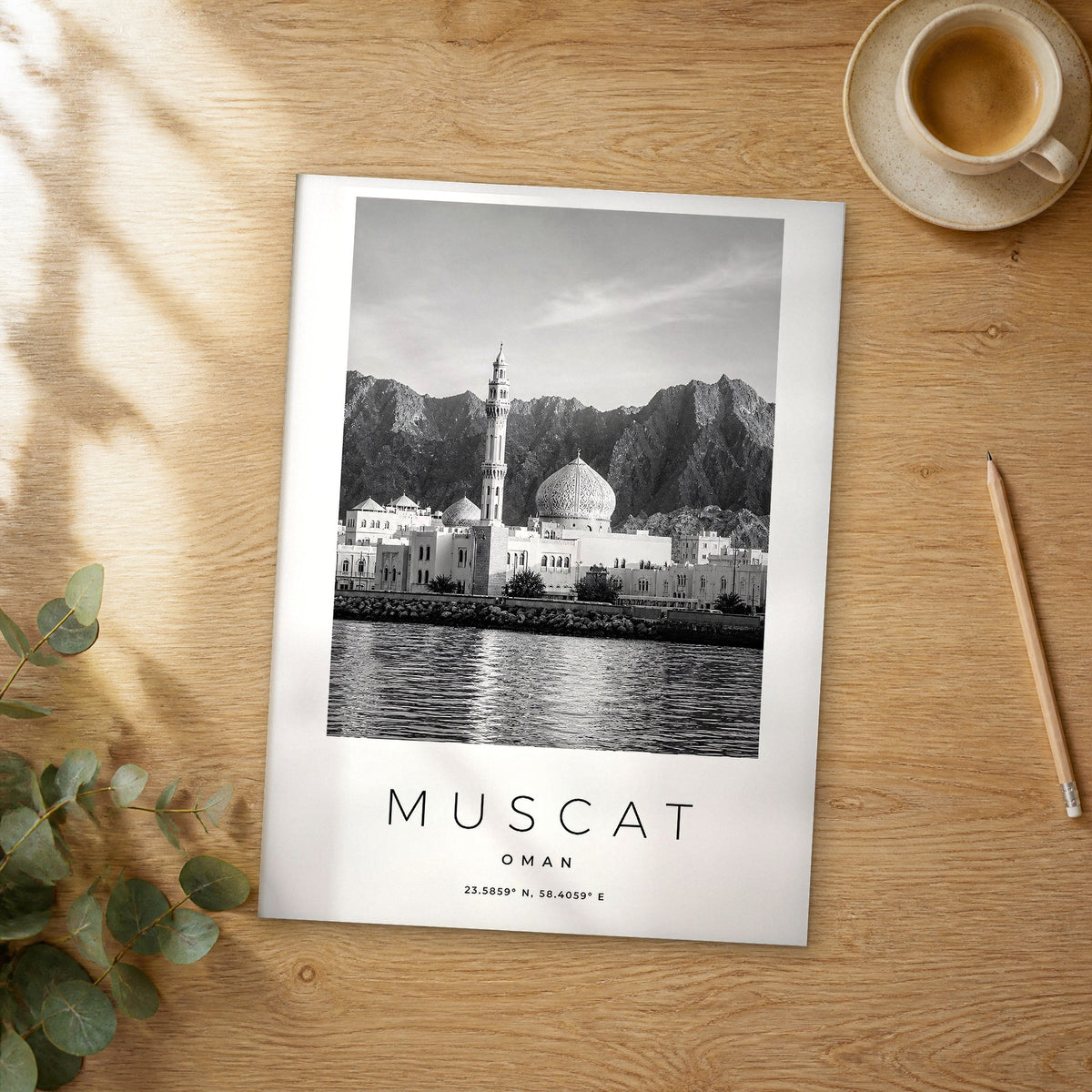 Unframed Muscat black and white travel poster on a wooden table