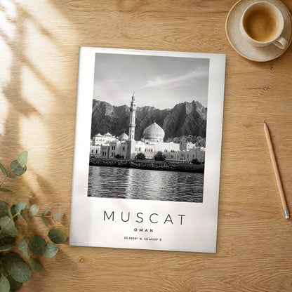 Unframed Muscat black and white travel poster on a wooden table