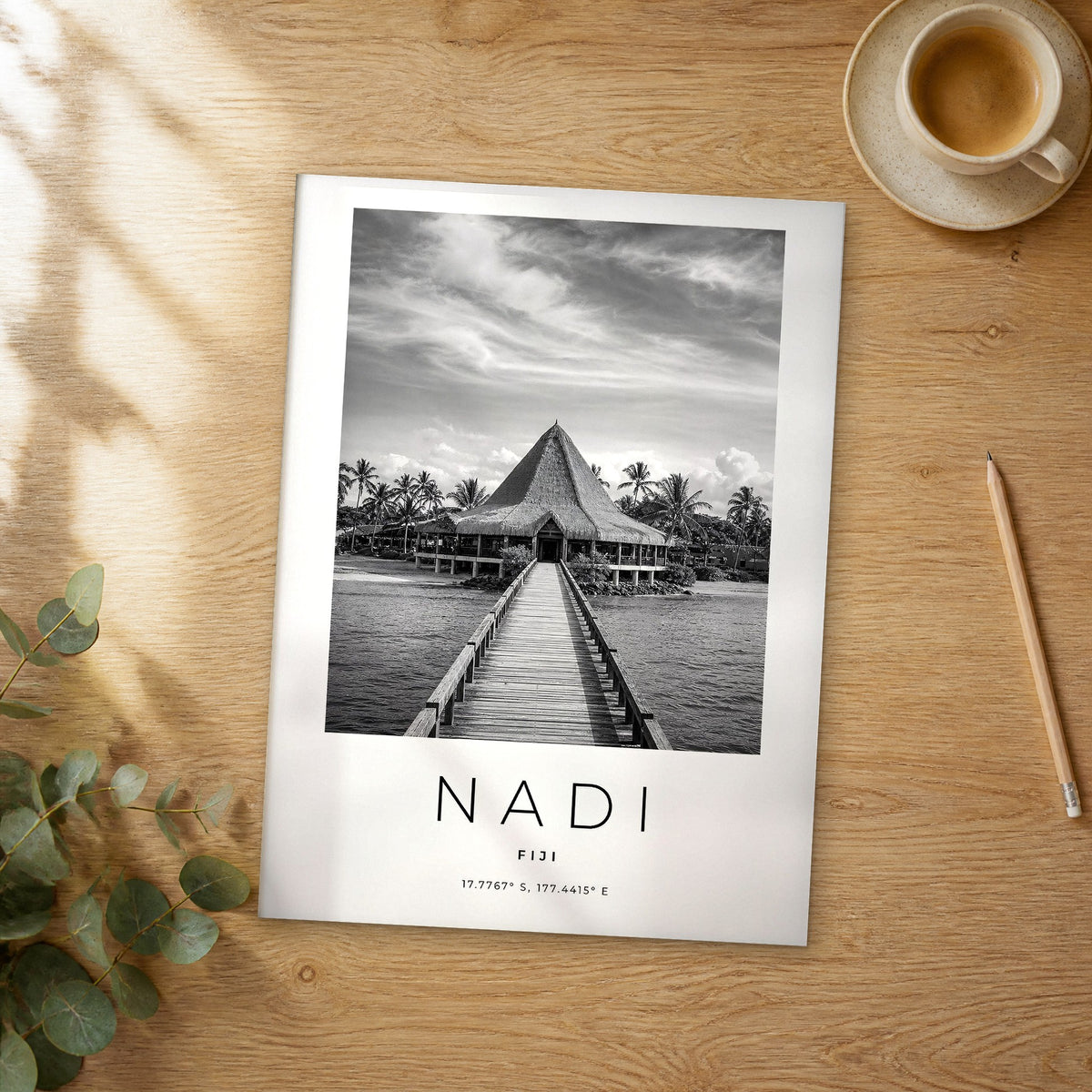 Unframed Nadi black and white travel poster on a wooden table