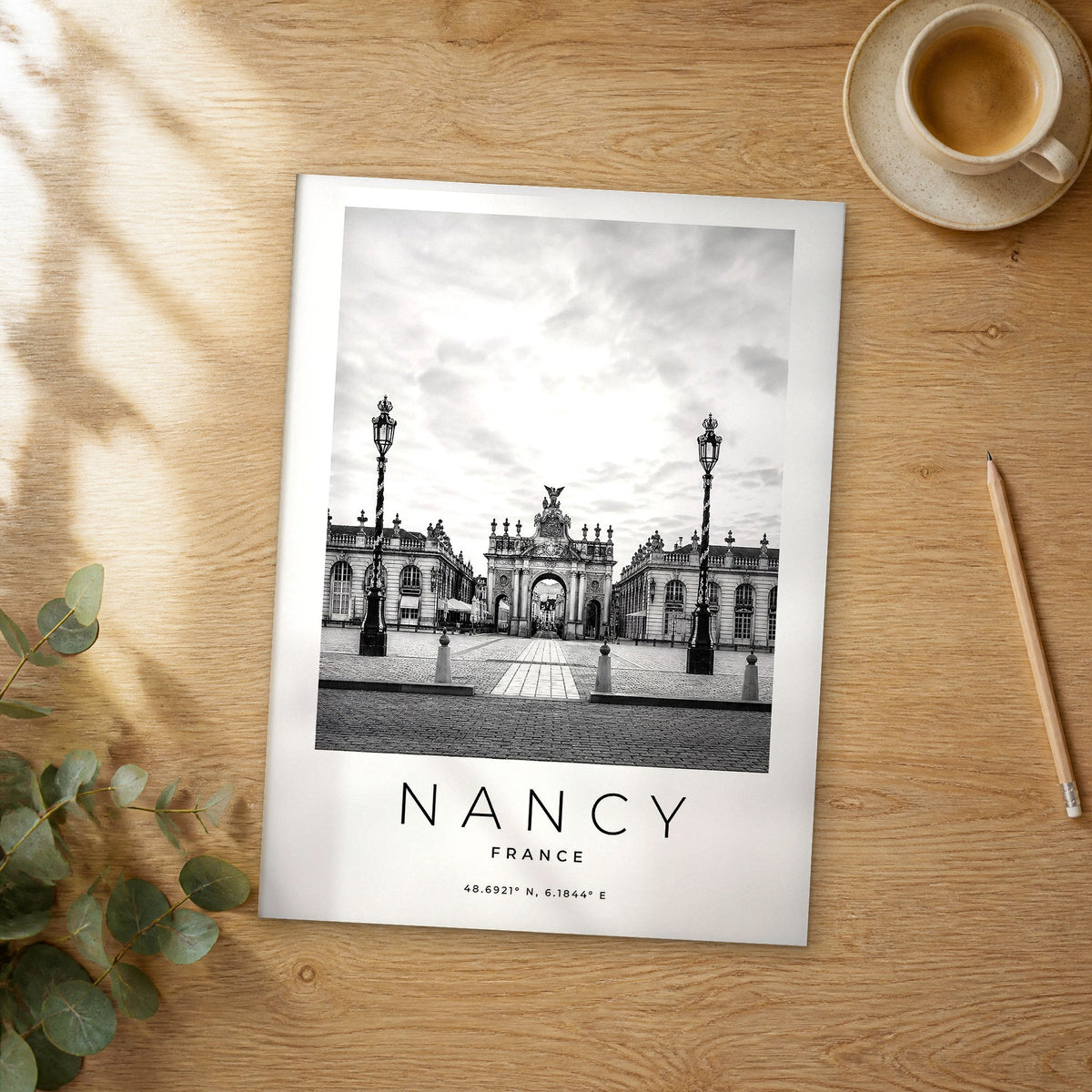 Unframed Nancy black and white travel poster on a wooden table