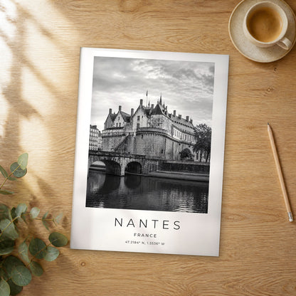 Unframed Nantes black and white travel poster on a wooden table
