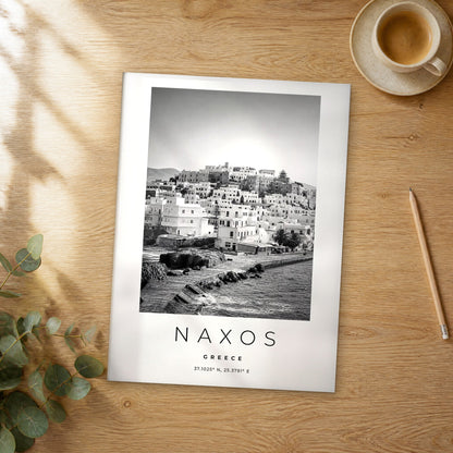 Unframed Naxos black and white travel poster on a wooden table