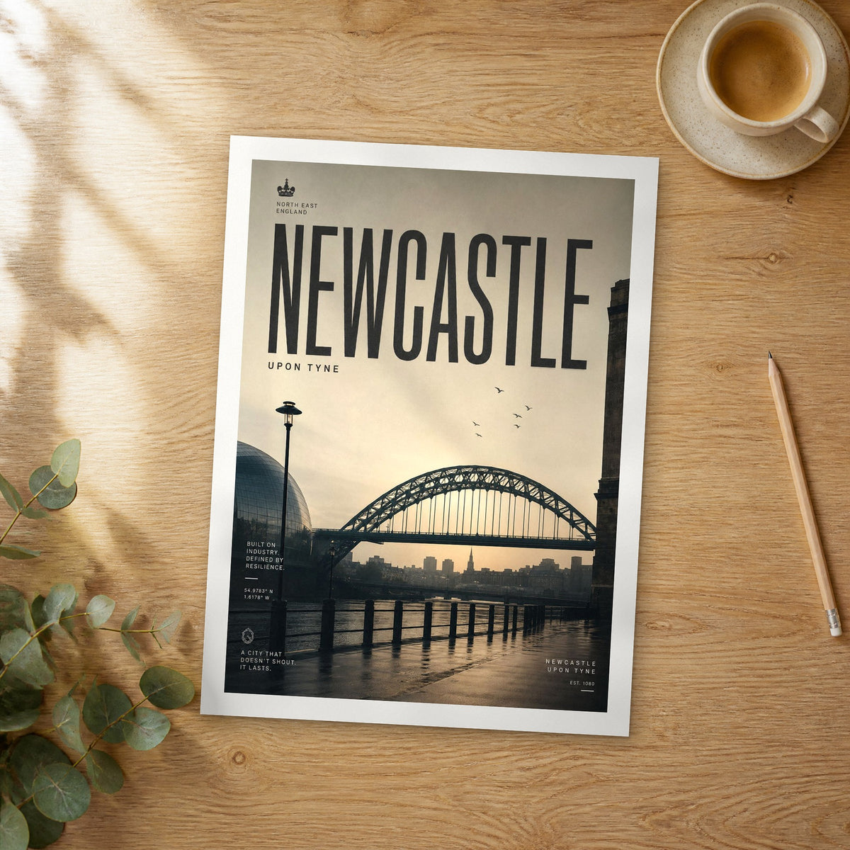Unframed Newcastle bold typography travel poster on a wooden table